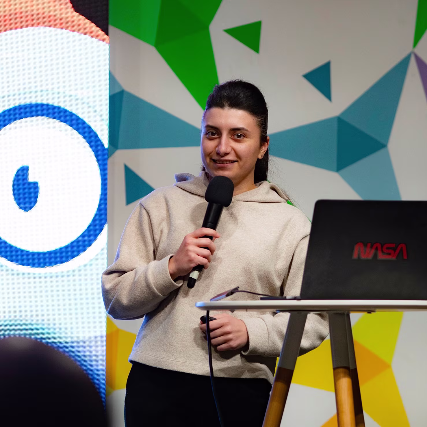 Djamile Abdullaeva on stage — designer and founder behind User First Shopify store design agency